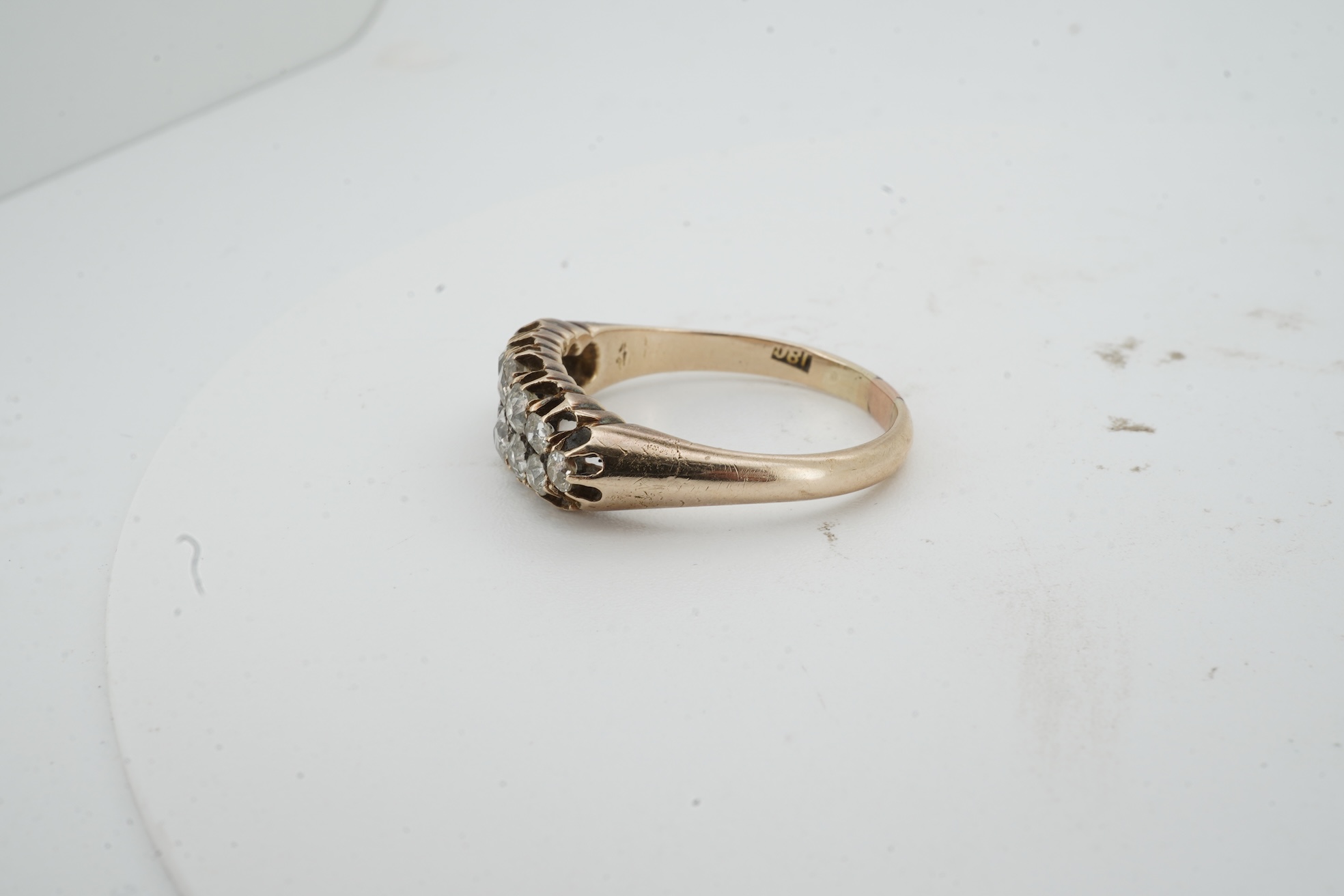 A diamond ring, early 20th century, pavé-set to the front with two rows of cushion-shaped diamonds totalling approximately 0.40 carats, mounted in gold, size O, gross weight approximately 3.5 grams